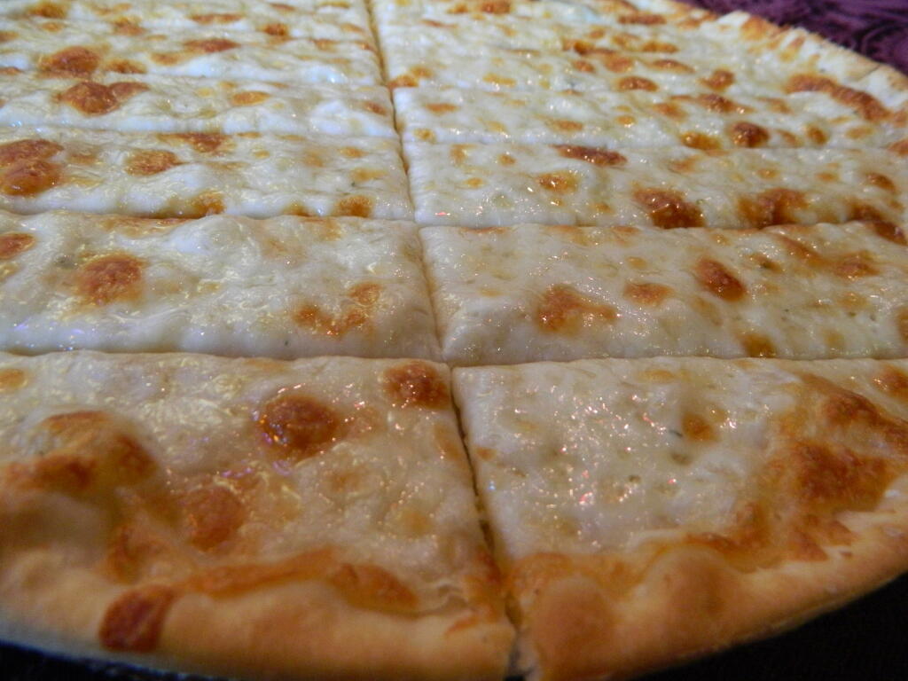 iFry Pizza crust covered with garlic butter and mozzarella cheese